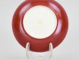 an image of a red and white plate on a stand