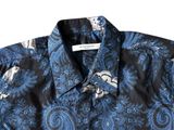 a close up of a shirt with a blue paisley pattern on it