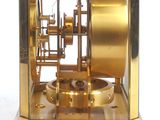 a gold clock that is sitting on top of a table
