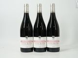 three bottles of wine sitting on top of a white table