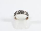 an image of a ring with black and white diamonds on a white surface