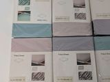 six sheets of bedding are stacked on top of each other on a table