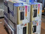 several boxes of electronic devices are stacked on pallets in a warehouse