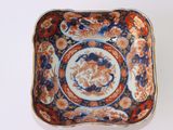 a small square bowl with a floral design on it