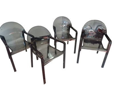 three clear plastic chairs sitting next to each other on a white surface
