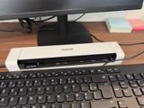 a keyboard and a monitor on a desk next to each other