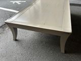 a white bench sitting in the middle of a parking lot