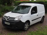 a small white van parked on the side of the road