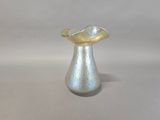 a small silver vase with a gold leaf on it