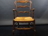 a wooden chair with a wooden seat on a black background