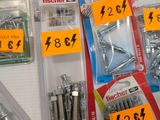 many different types of screws and nuts in the package