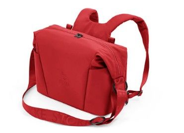 a red backpack with a shoulder strap on a white background