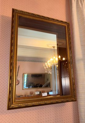 a mirror hanging on the wall in a room