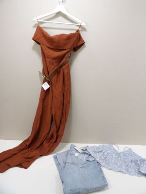 a brown dress hanging on a wall next to a pair of jeans