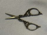 two pairs of scissors that are on a cloth