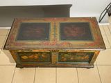 a small wooden box with a painting on it