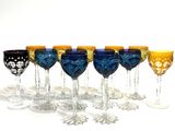 seven wine glasses lined up in a row on a table