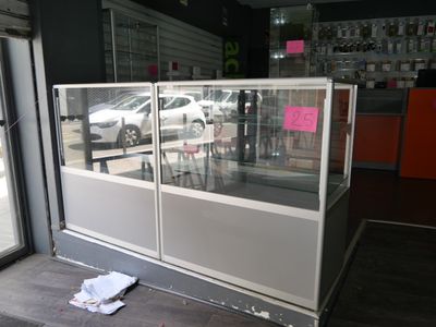 a glass display case in the corner of a store