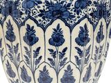 a blue and white vase sitting on a white surface