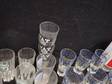 bottles and glasses are lined up on a black surface