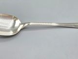 a close up of a spoon with a handle on a table