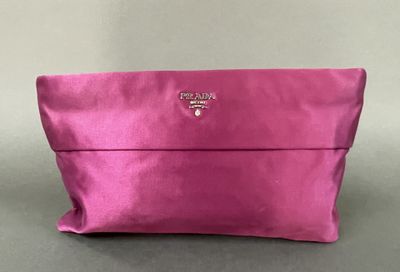 a pink purse with a small logo on the front