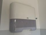 a toilet paper dispenser on the wall in the bathroom