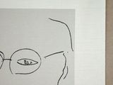 a drawing of a man with glasses on a piece of paper
