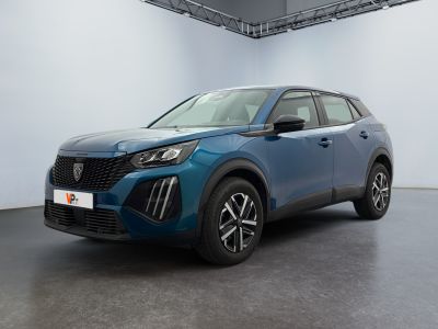 the blue suv is parked in a large room with a white wall