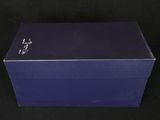an empty blue box on a black surface with a black background