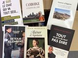 several books are sitting in a cardboard box on a table