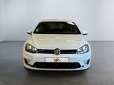 the white volkswagen golf is parked in a large room