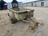 a small trailer that is sitting in the dirt