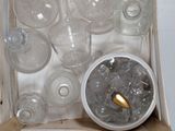 a box full of empty glass bottles and a gold spoon