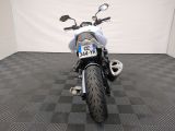 a motorcycle that is parked in a room with a checkered floor