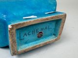 a blue suitcase sitting on a table with a tag on it