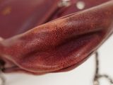 a red purse with a chain hanging from it
