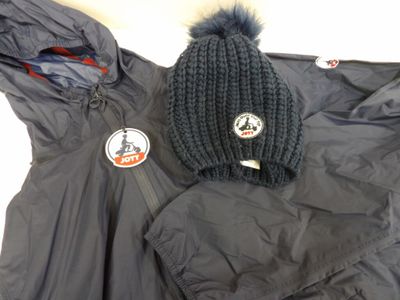 a coat, hat, and jacket laying on the floor