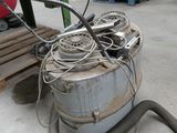 a large metal drum with a hose and a hose attached to it