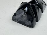 a black object that is sitting on a white surface
