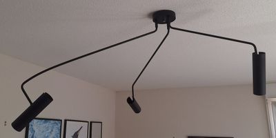 a picture of a room with a bed and a ceiling light
