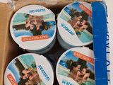 a cardboard box with four cans of wax on top of it