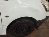 a white truck that has been painted white in a garage