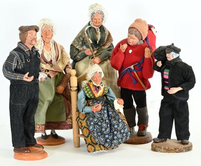 five figurines of people sitting on a chair