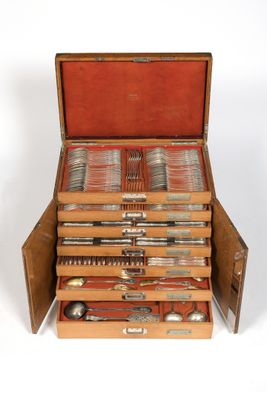 a wooden box with silverware in it on a white surface