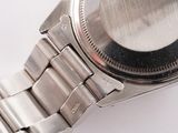 a close up of a watch on a white surface