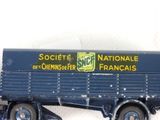 a toy truck with a sign on the side of it
