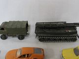 several toy cars and trucks are lined up on a white surface
