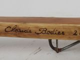 a baseball bat with a name on it sitting on a table