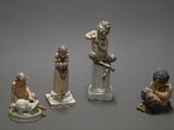 several figurines of different sizes and shapes on a gray surface
